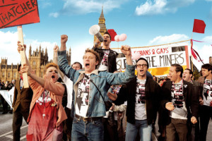 (Front row, left to right) Faye Marsay as Steph, George Mackay as Joe, Joseph Gilgun as Mike, Paddy Considine as Dai and (second row, with megaphone) Ben Schnetzer as Mark in PRIDE to be released by CBS Films. Photo credit: Nicola Dove